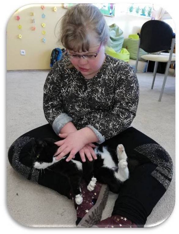 Felinoterapia - na zdjęciu dziewczynka z kotem